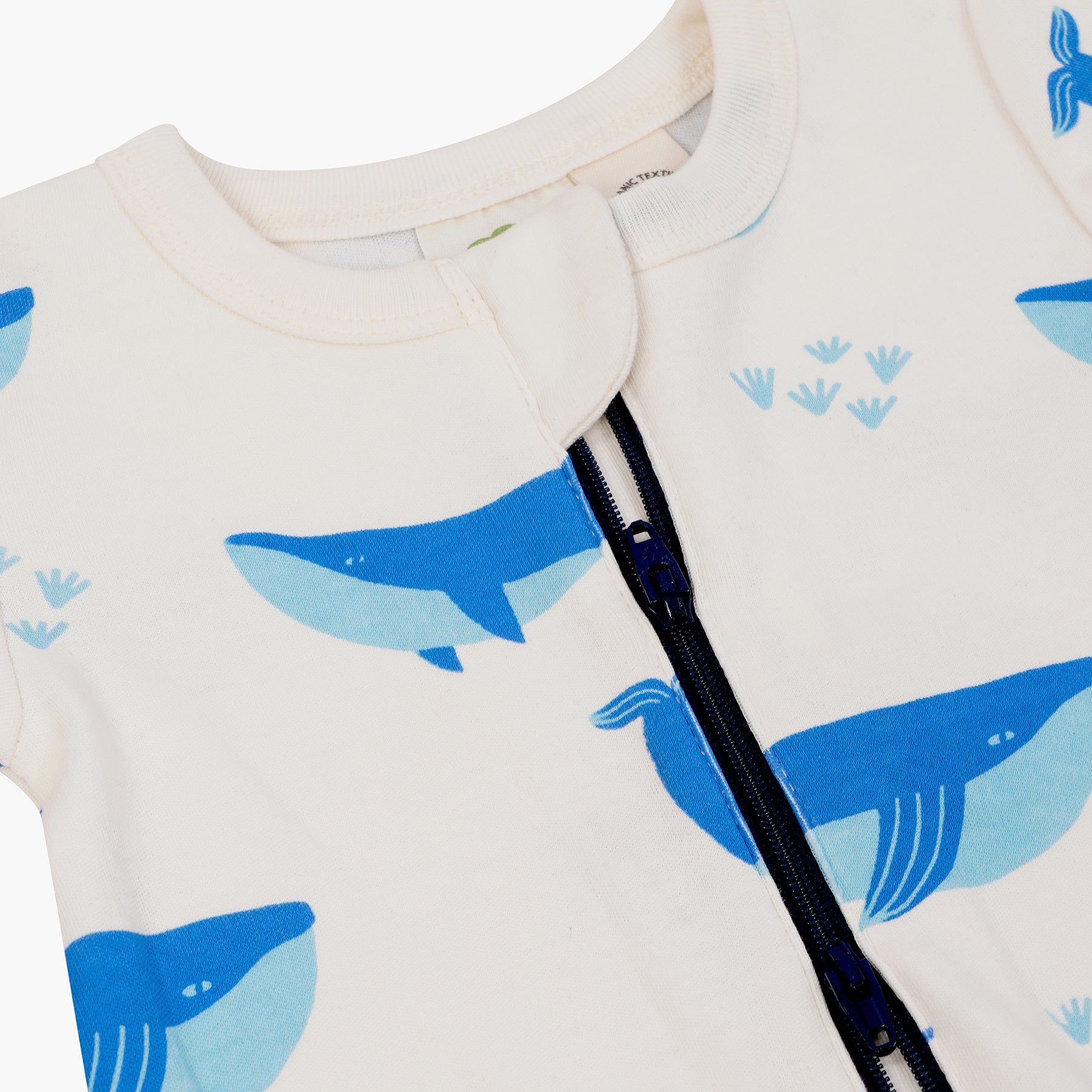 Baby zipper romper with blue whale patterns on a white background